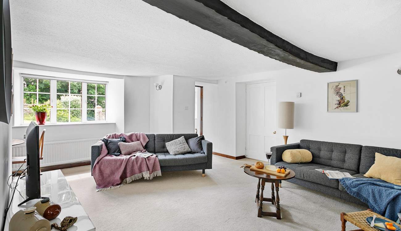A gorgeous wooden beam runs across the second sitting-room's ceiling.