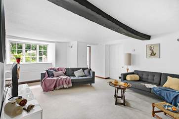 A gorgeous wooden beam runs across the second sitting-room's ceiling.