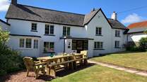 Enjoy the Devonshire sunshine on the wonderful lawn at Friends Farmhouse a wonderful 300-year-old getaway for all the family.