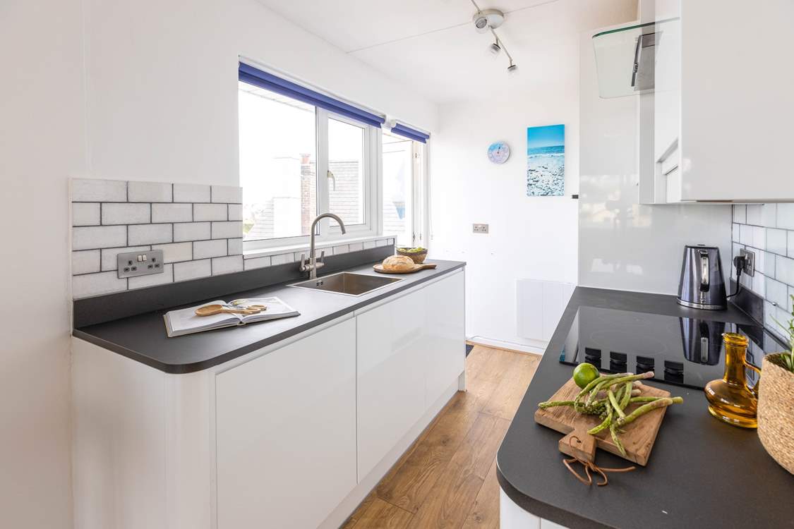 The sleek kitchen has all you need to cook a culinary delight, including the all-important dishwasher.