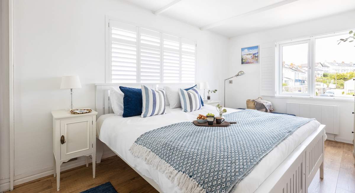 The gorgeous bedroom has a super-king size bed and a view towards Gull Rock.