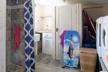 You can store your wetsuits and bodyboards next to the washing machine and tumble-drier and you'll also find a shower here too.