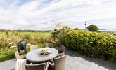 The secluded patio at the rear of Willow's Place overlooks a pretty meadow towards Gull rock and beyond. - Thumbnail Image