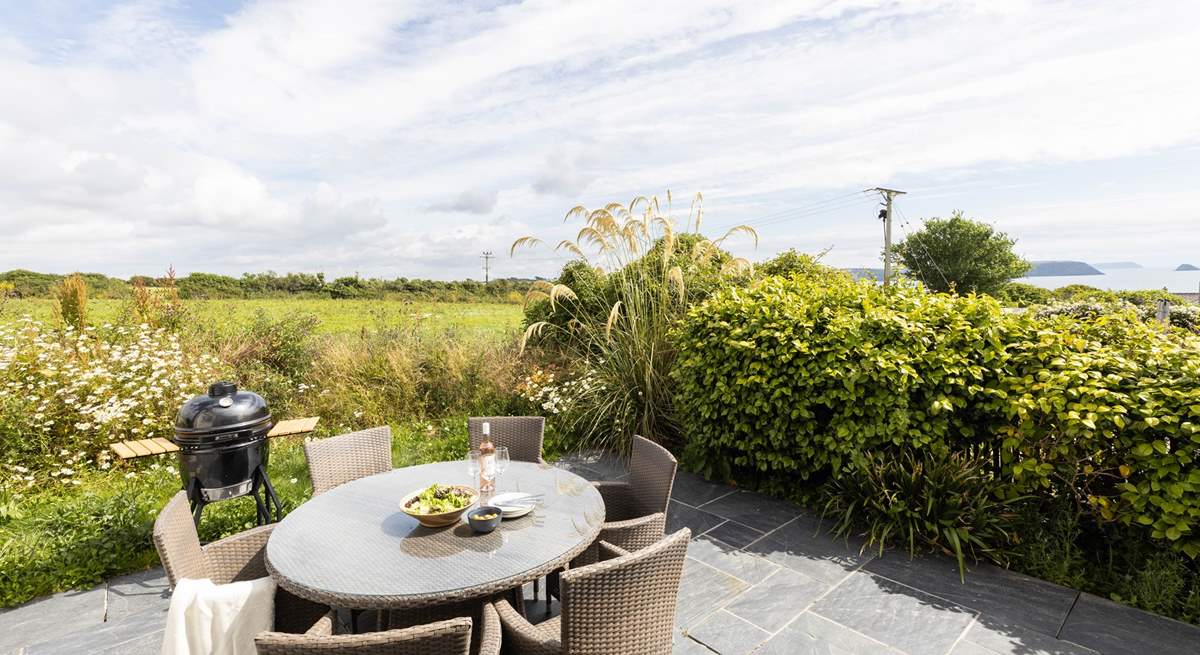 The secluded patio at the rear of Willow's Place overlooks a pretty meadow towards Gull rock and beyond.