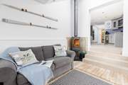 Down a short flight of steps from the kitchen you will find the gorgeous snug with super comfy sofa and wood-burner.