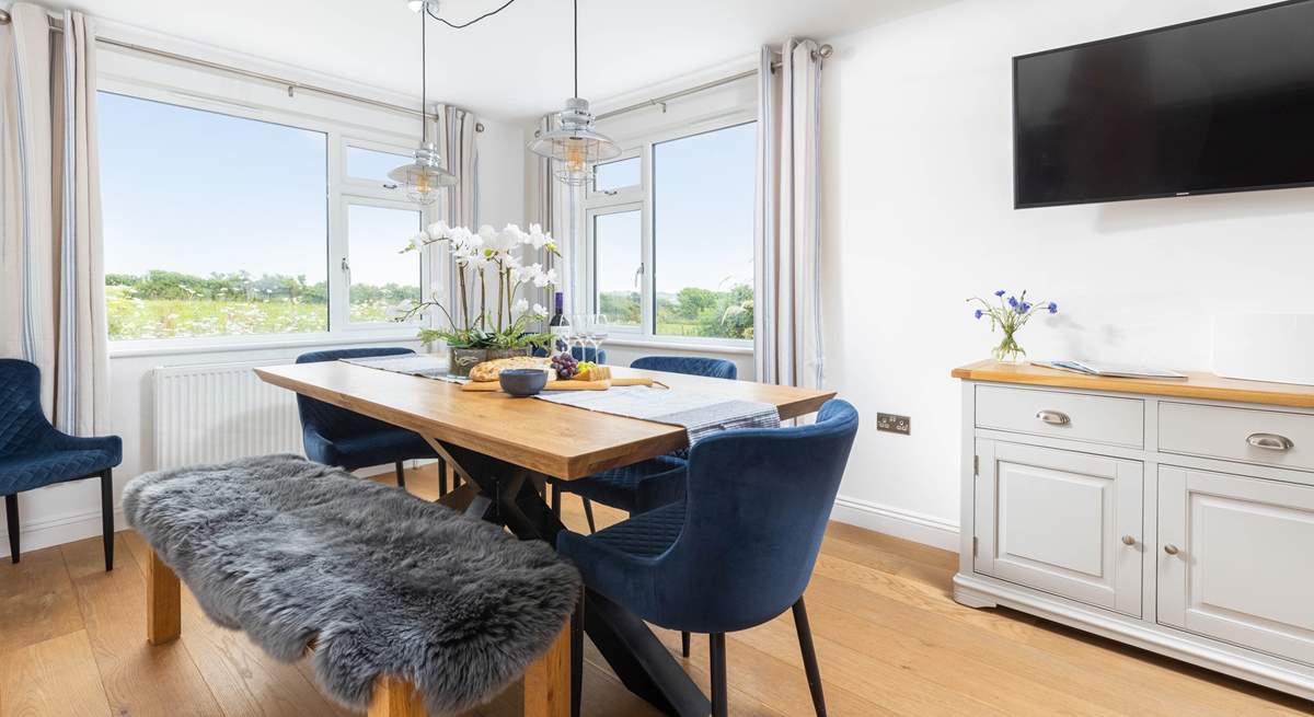 The gorgeous dining-area is beautifully created with statement lighting.