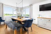 The gorgeous dining-area is beautifully created with statement lighting.
