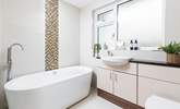 The swish family bathroom has a gorgeous free-standing bath and a walk-in shower. - Thumbnail Image