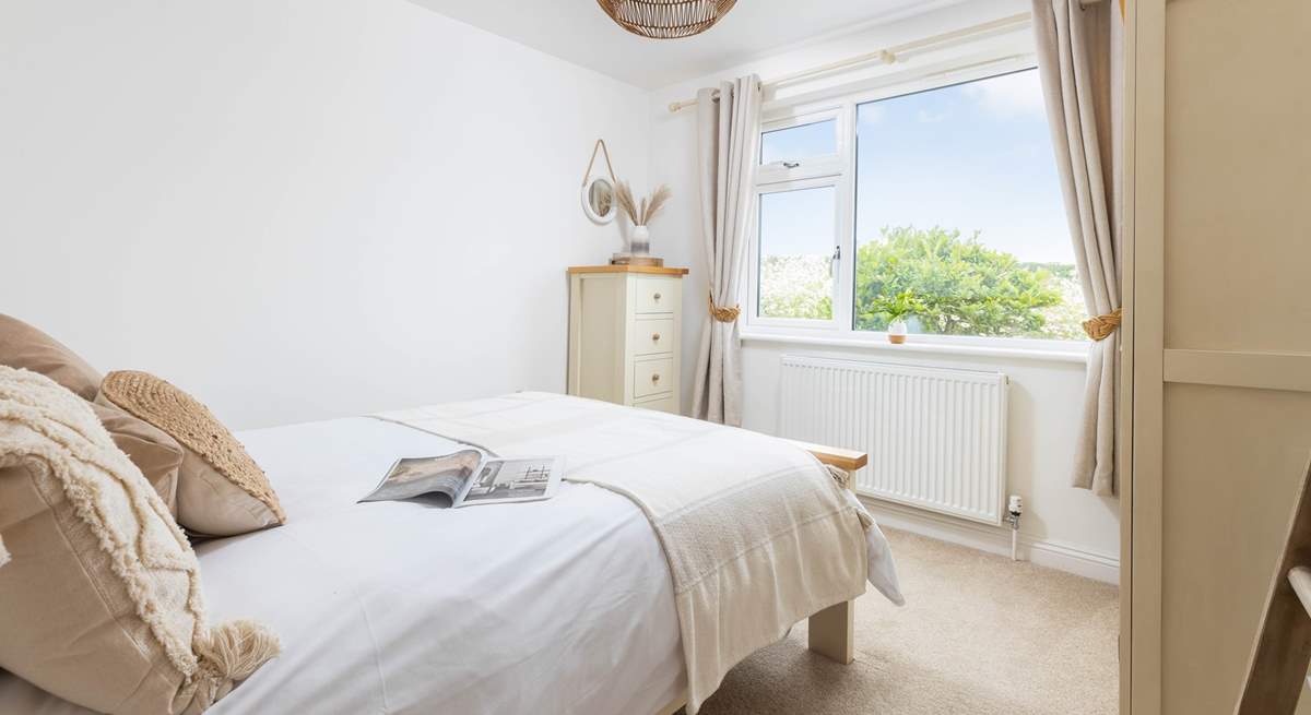 The double bedroom on the ground floor is beautifully decorated in muted tones.