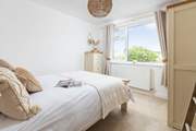 The double bedroom on the ground floor is beautifully decorated in muted tones.