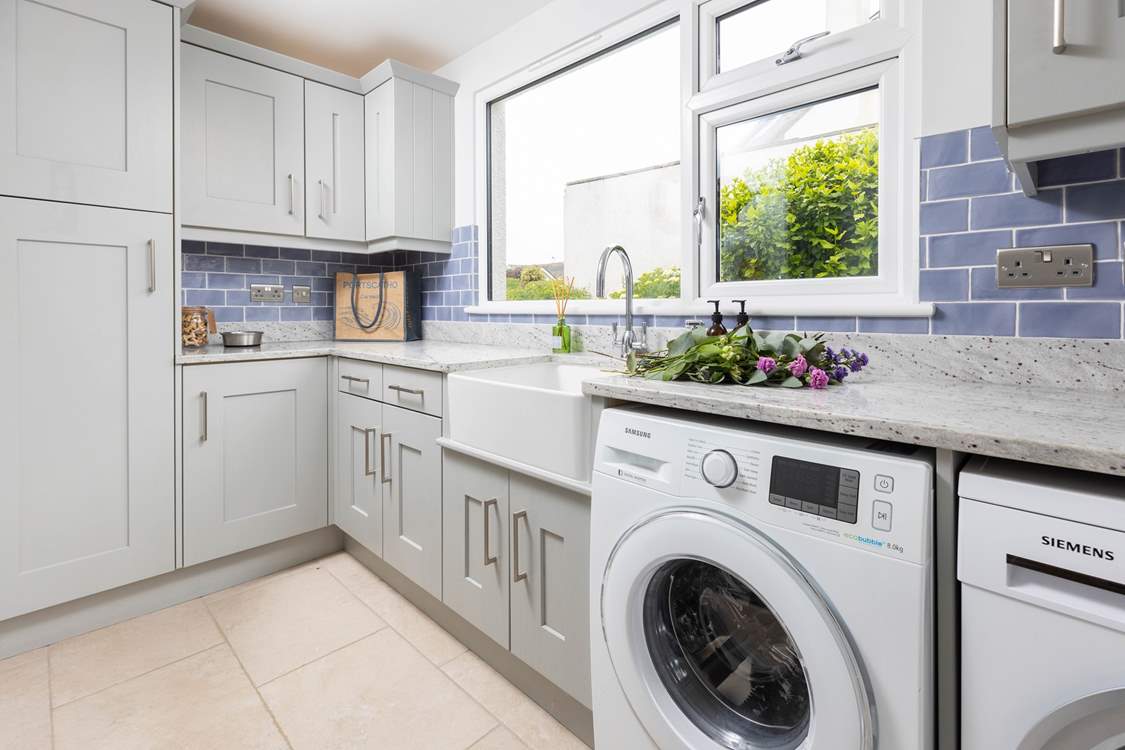 The handy utility-room off the kitchen has a washing machine and drier.