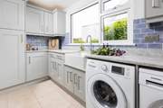 The handy utility-room off the kitchen has a washing machine and drier.