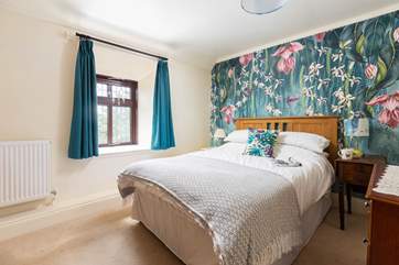 What a fabulously cosy and colourful double room (Bedroom 2).
