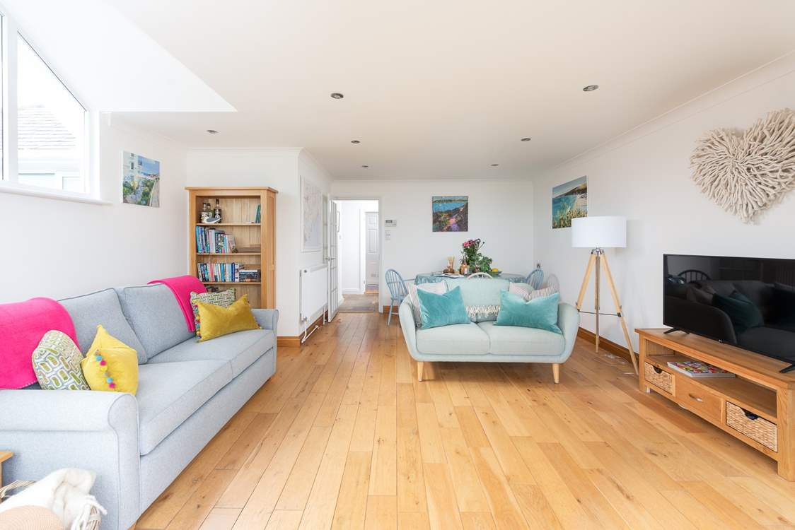The spacious sitting/dining-room is lovely.