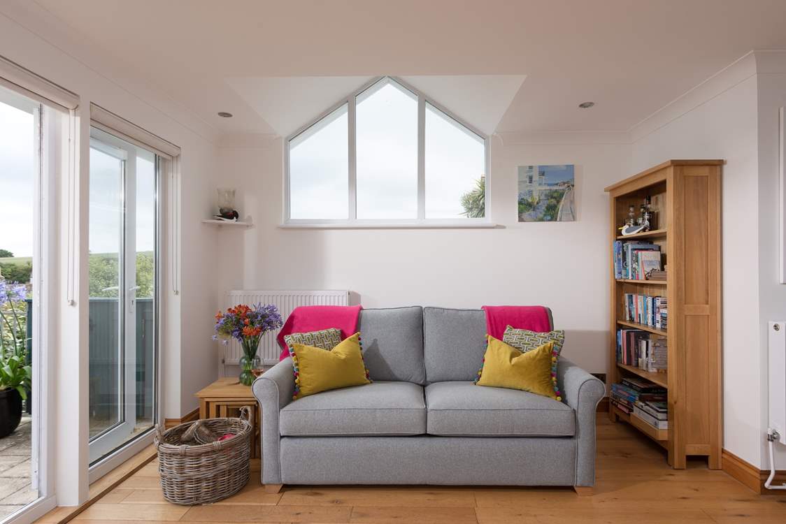 The apex window and patio doors make the sitting/dining-room light and bright.