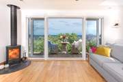 The gorgeous balcony overlooks the lush vegetation and rooftops towards Gerrans Bay.