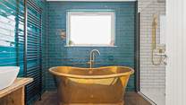The en suite Bathroom has this fabulous roll-top bath and a stunning rainfall shower.