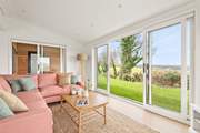 The open plan living space has a delightful sitting-area with comfy sofas.