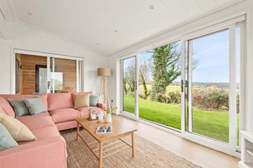 The open plan living space has a delightful sitting-area with comfy sofas.