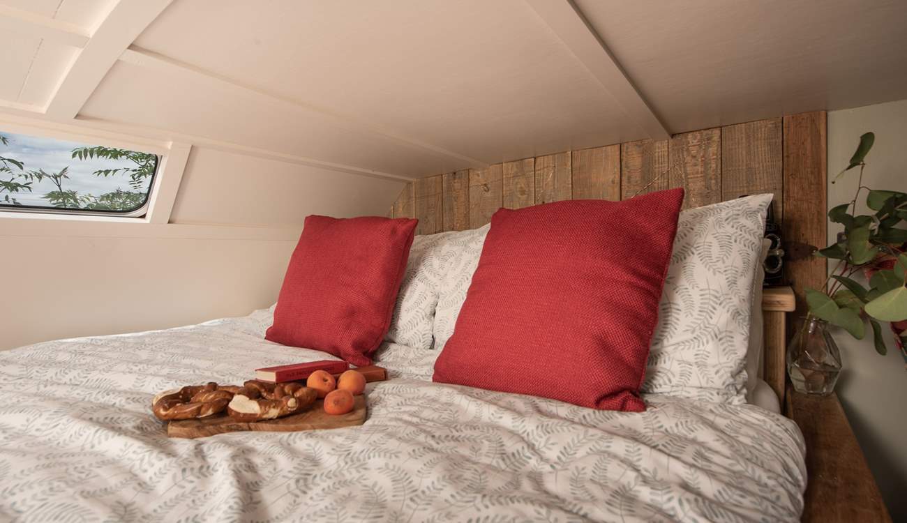 The cosy, raised double bed is idyllic for a peaceful night's sleep. 