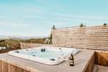 Sink into the bubbling hot tub and admire the sweeping countryside vistas. 