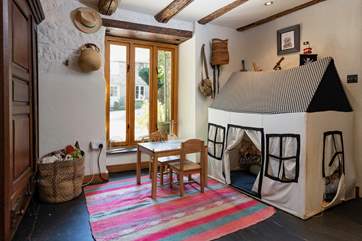The delightful entrance hall can double up as a cheerful playroom for little ones.
