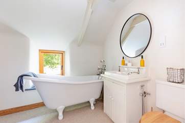 A beautifully finished bathroom sits next door.