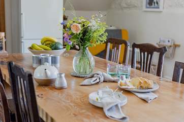 Beautifully crafted chairs surround the rustic dining-table.