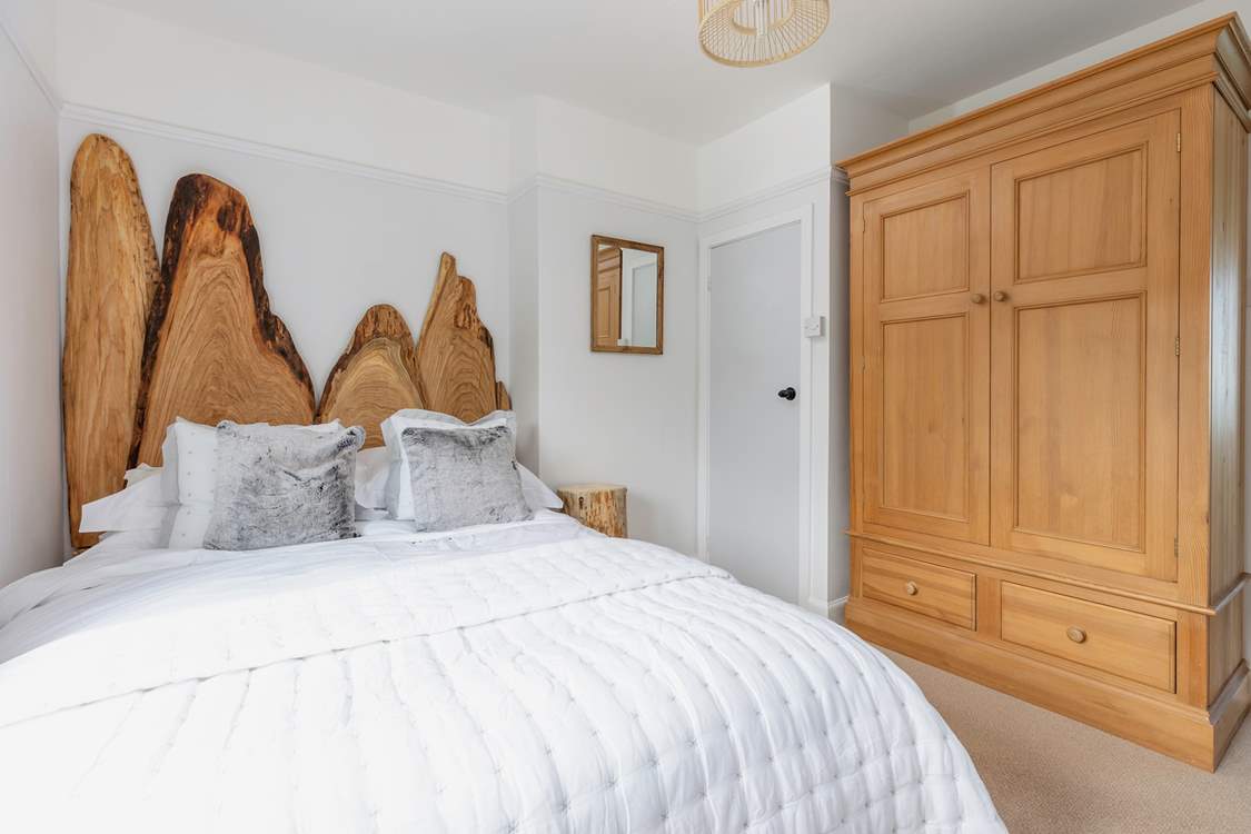 Dreamy bedroom 2 has a fabulous headboard and super comfy king-size bed.