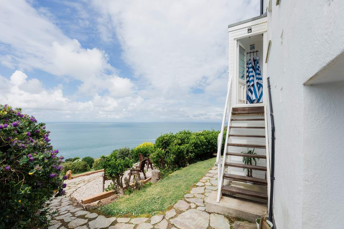 Walk down the steps and enjoy a garden that will delight from dawn to dusk.  If the steps aren't for you there is access around the side of the house however this is not flat.