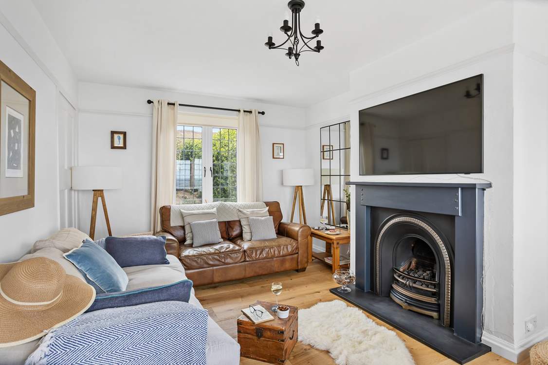 The sitting-room is beautifully furnished with comfort in mind.