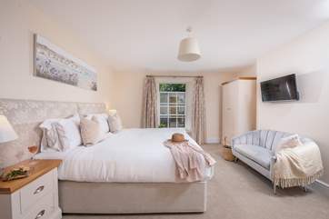 Lovely bedroom 3 has a sweet seating-area.