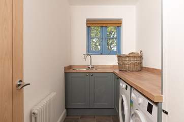 The handy utility-room has a washing machine and a tumble-drier.