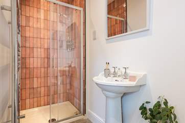The family bathroom has a shower and a bath.