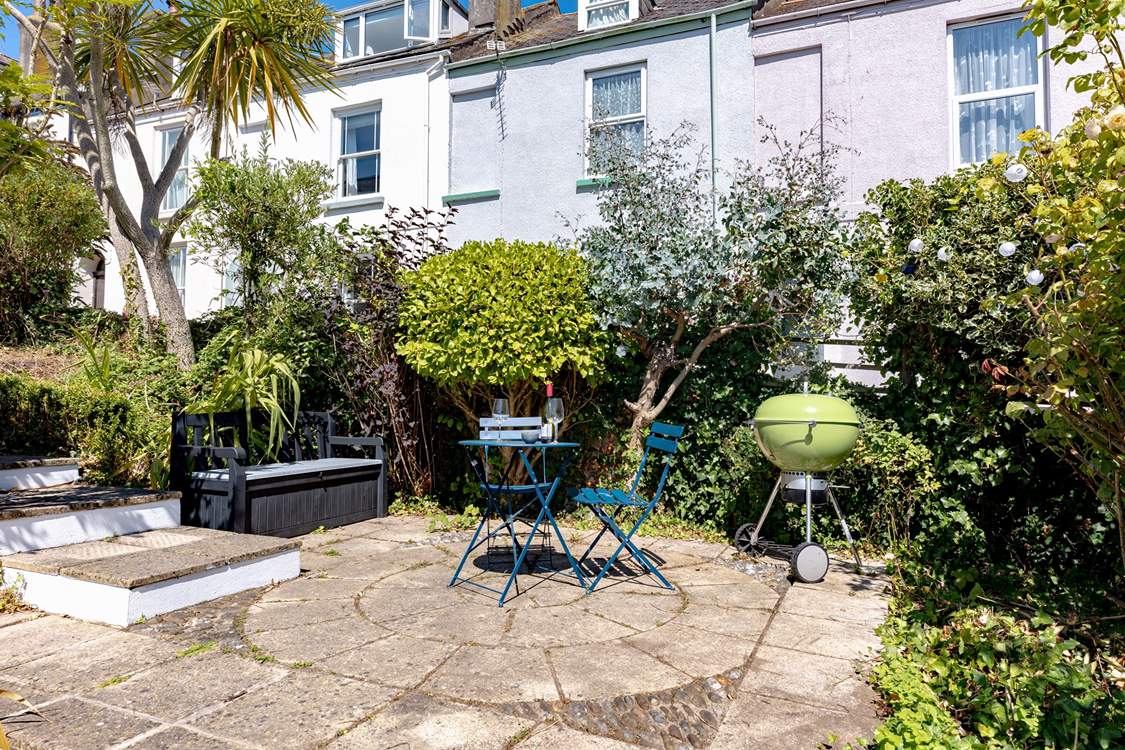 The pretty garden has several secluded spots, the L shape sofa will be moved to this position to make the most of the last of the evening sun with views down to the estuary.
