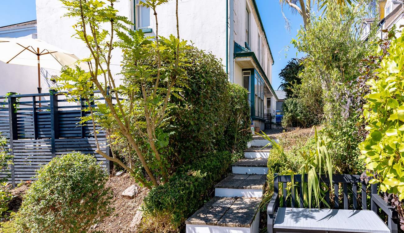 Steps lead down to the garden area.