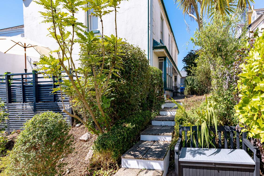 Steps lead down to the garden area.