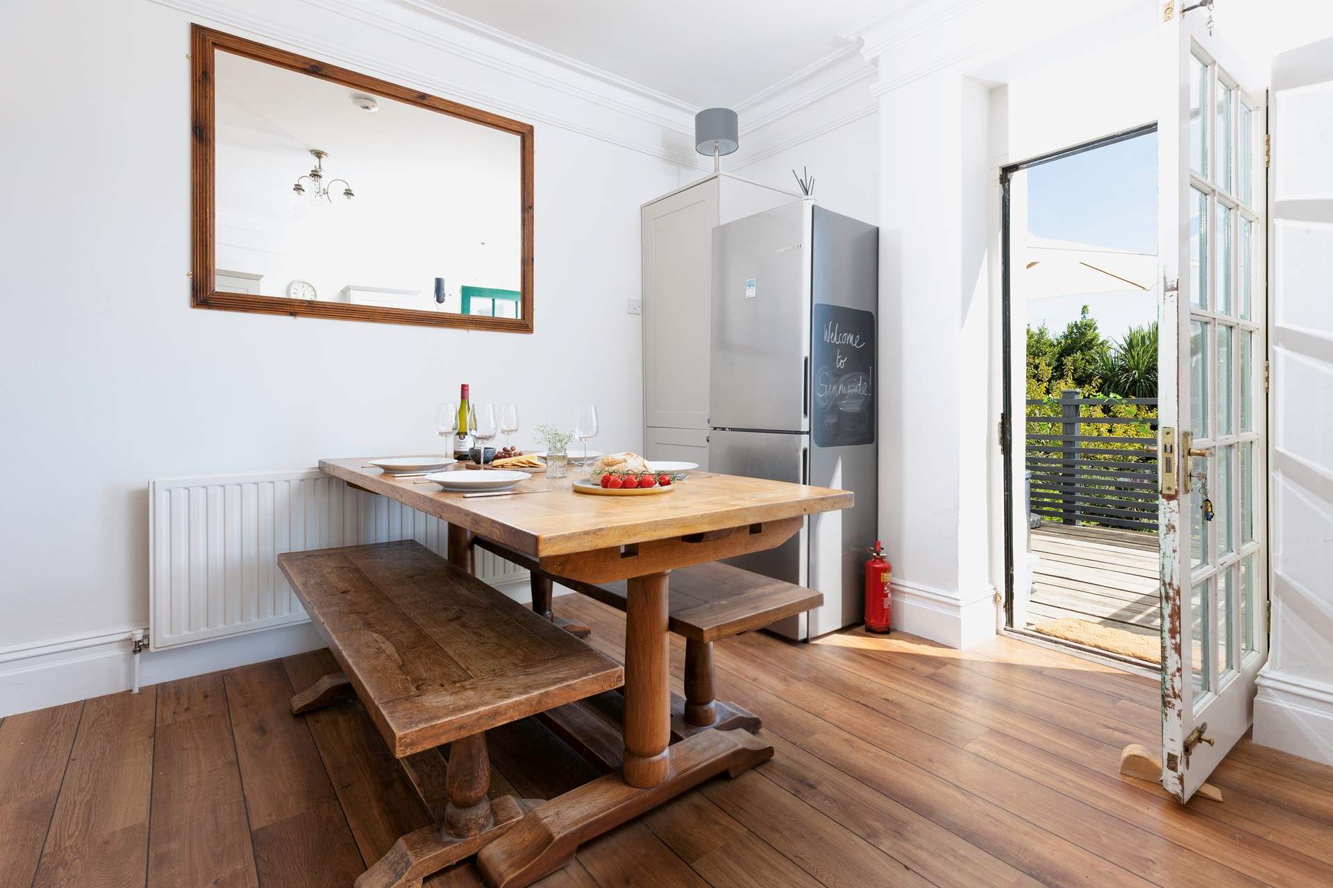 At meal times you can choose to dine either at the gorgeous refectory table in the kitchen/diner or sit in the Devon sunshine on the terrace outside. The kitchen table can seat eight guests and there are two extra chairs in the cupboard.