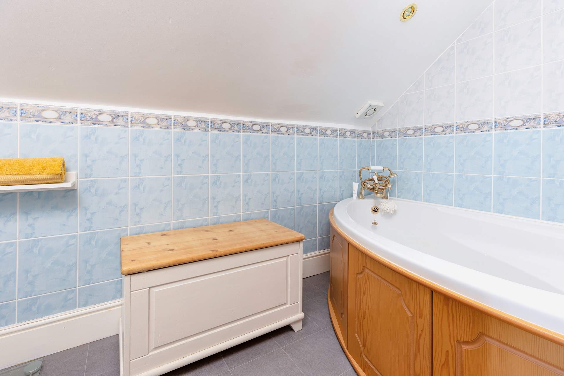 The en suite bathroom to bedroom 4 has a corner bath with hand shower attachment. Please note, there is a macerator toilet which will make a unique sound when flushed. Please take care around the sloping ceiling.