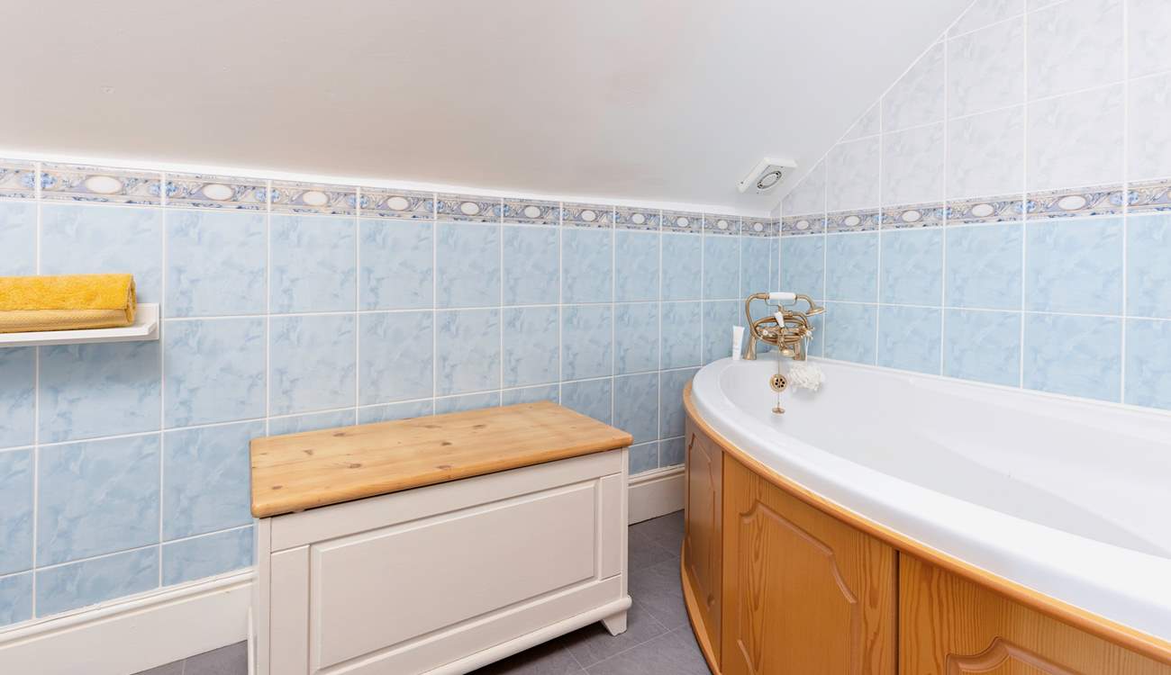The en suite bathroom to bedroom 4 has a corner bath with hand shower attachment. Please note, there is a macerator toilet which will make a unique sound when flushed. Please take care around the sloping ceiling.