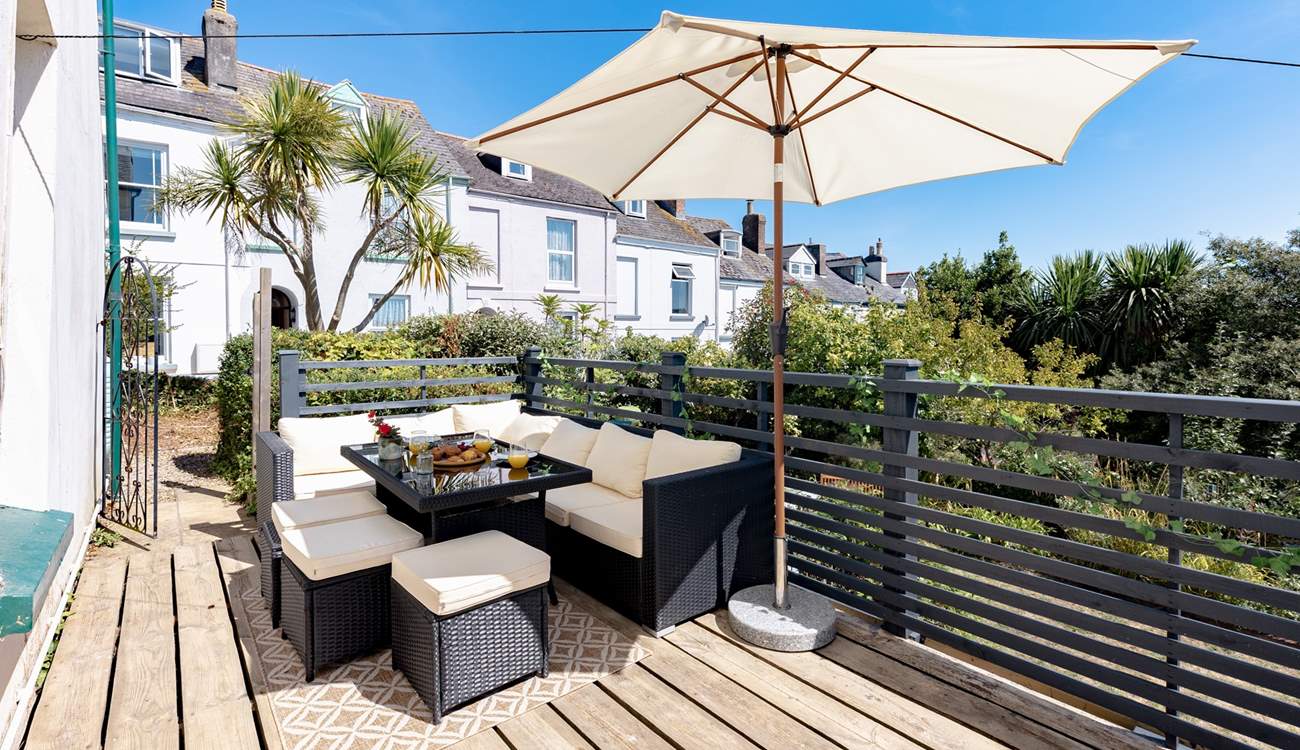 This quiet suntrap invites you to dine from dawn until dusk. The gate leads to the front of the house and steps down to the lower garden and patio area.