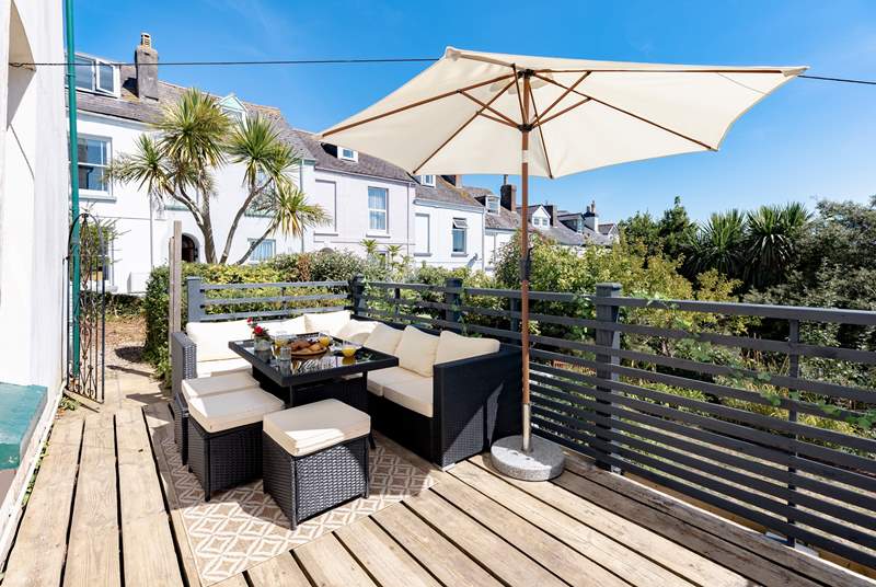 This quiet suntrap invites you to dine from dawn until dusk. The gate leads to the front of the house and steps down to the lower garden and patio area.