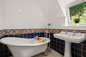 The luxurious free-standing bath is the perfect place to relax after a long day.