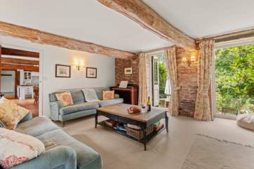 Gorgeous wooden beams and exposed stone walls make the sitting-room super snug.