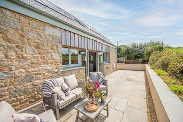 Outside, there's a delightful sitting area perfect for soaking up the Cornish sun.