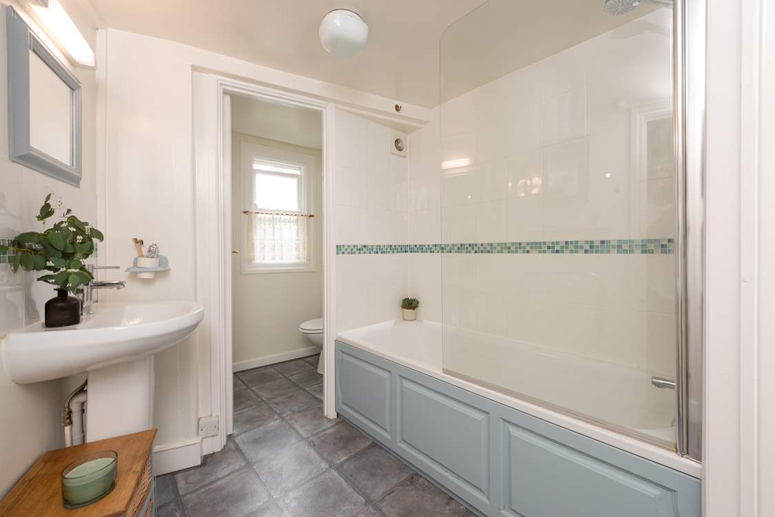 Unwind in the inviting bathtub after a day on the beach. The family bathroom is located on the first floor.