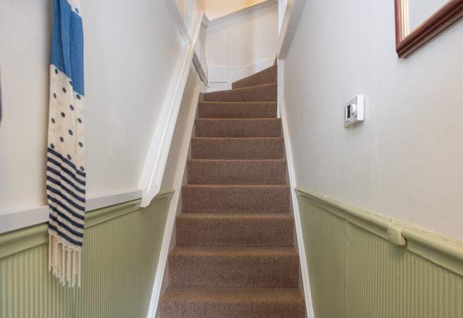You'll be greeted by a small entrance hall and stairs up to the apartment.