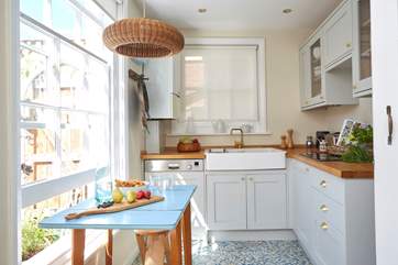 The kitchen is beautifully crafted with dove grey units and a Belfast sink.