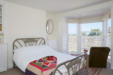This pretty double bedroom has a lovely bay window, the perfect spot for a holiday read.
