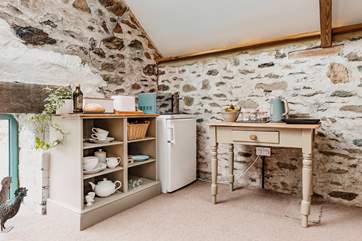 The simple kitchen is complete with all the essentials for rustling up holiday meals (please note, there is no sink in the kitchen however dishes can be washed in the wash-basin in the en suite or in the shared shower-room)